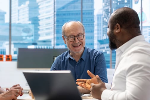 Elderly_People_Discussing_With_A_Professional_Banker_About_Retirement_Plans_original_2644357