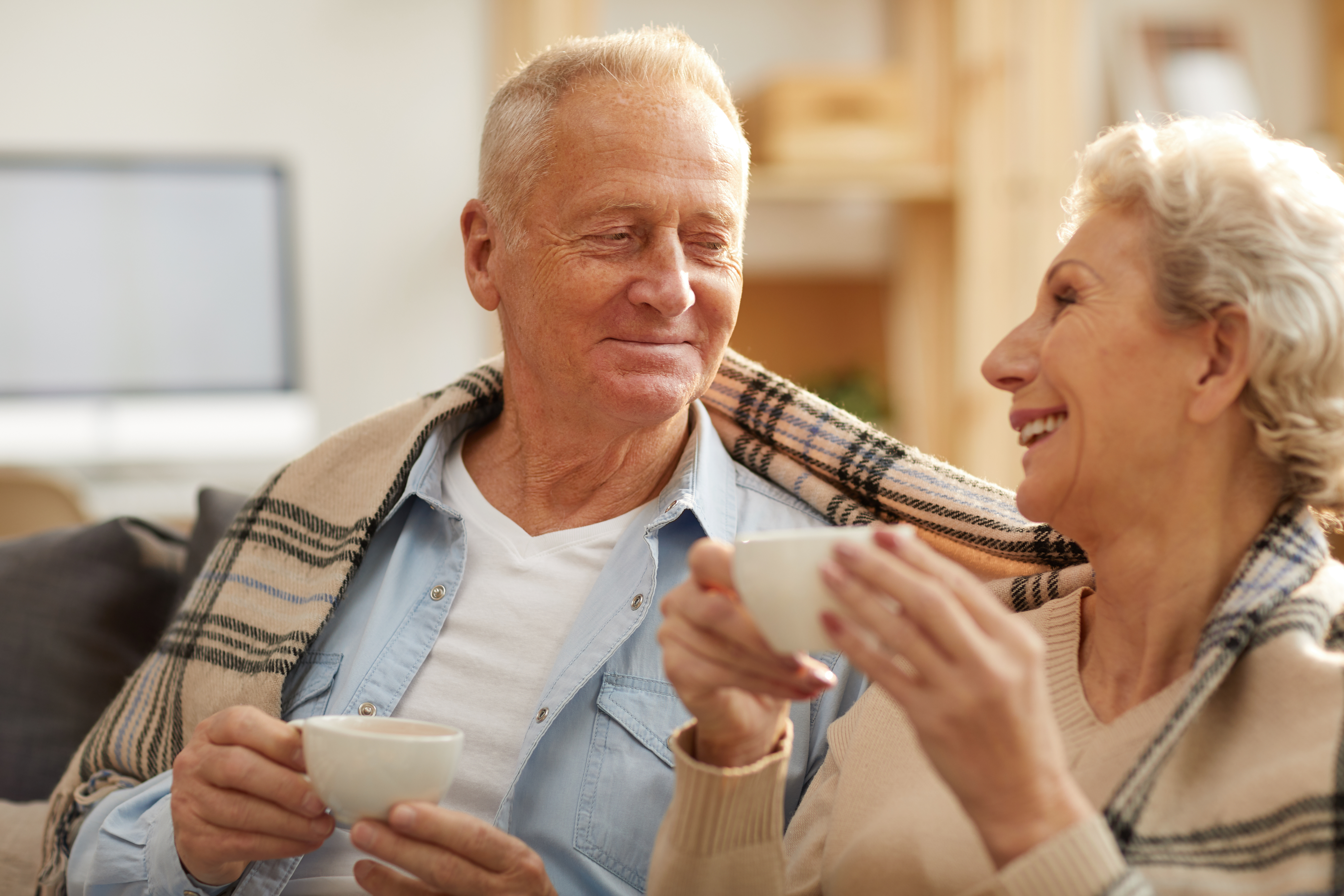 Two seniors enjoying a morning cup of coffee